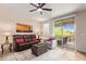 Bright living room with a plush sofa, chair, and access to a private balcony through sliding glass doors at 1945 W Desert Vista Trl # 77, Phoenix, AZ 85085