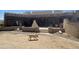 Large backyard featuring a patio, outdoor fireplace, and mature landscaping at 20042 W Colter St, Litchfield Park, AZ 85340