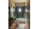 Cozy bathroom featuring tiled walls, a vanity sink, and a shower with green curtains at 20042 W Colter St, Litchfield Park, AZ 85340