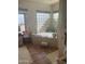 Bright bathroom featuring a soaking tub and tile surround at 20042 W Colter St, Litchfield Park, AZ 85340