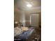 Bedroom with ceiling fan, armoire, and a bed with a patterned comforter at 20042 W Colter St, Litchfield Park, AZ 85340