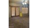 Bedroom with neutral carpet, double doors to a patio and a ceiling fan at 20042 W Colter St, Litchfield Park, AZ 85340