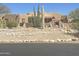 A charming desert home featuring lovely landscaping with cacti and native vegetation at 20042 W Colter St, Litchfield Park, AZ 85340
