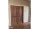 Interior view of a stylish wooden double-door closet with hardwood floors at 20042 W Colter St, Litchfield Park, AZ 85340