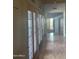 Hallway with wood floors and light from French doors on the left at 20042 W Colter St, Litchfield Park, AZ 85340