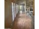 Inviting hallway with wood-look floors, wood trim, and natural light from the French door-style windows at 20042 W Colter St, Litchfield Park, AZ 85340