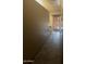 Hallway with tile flooring leads to a glass-paneled door, showcasing natural light at 20042 W Colter St, Litchfield Park, AZ 85340