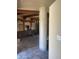 Open living space with exposed wood beams, a brick accent wall, and tile flooring at 20042 W Colter St, Litchfield Park, AZ 85340