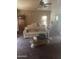 Living room with white couch, glass coffee table, and various decorative items at 20042 W Colter St, Litchfield Park, AZ 85340