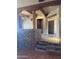 Living room with rustic beams, brick accents, and staircase at 20042 W Colter St, Litchfield Park, AZ 85340