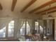The living room has three sets of double doors and wooden beams on the ceiling at 20042 W Colter St, Litchfield Park, AZ 85340