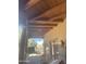 This covered patio has a wooden ceiling, desert views, and tan painted walls at 20042 W Colter St, Litchfield Park, AZ 85340