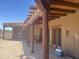 Spacious patio with exposed wood beams, multiple access points, brick flooring, and outdoor living space at 20042 W Colter St, Litchfield Park, AZ 85340