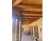 Wide patio with exposed wood beams, brick flooring, multiple access points, and space for a dining set at 20042 W Colter St, Litchfield Park, AZ 85340