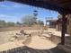 Backyard pool featuring an unfinished pool with rustic rock features, set in a spacious patio area at 20042 W Colter St, Litchfield Park, AZ 85340