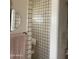 Shower with white tiled walls and a seated bench at 20042 W Colter St, Litchfield Park, AZ 85340