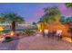 Enjoy a relaxing evening on this cozy brick-paved patio with lush desert landscaping and charming accent lighting at 20555 N 261St Ave, Buckeye, AZ 85396