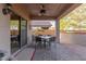 Covered patio with ceiling fan and dining set offers a relaxing outdoor living space at 20555 N 261St Ave, Buckeye, AZ 85396