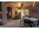 Warmly lit covered patio with dining table and chairs, perfect for outdoor entertaining at 20555 N 261St Ave, Buckeye, AZ 85396