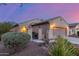 Beautiful single-story home featuring a charming front gate, well-maintained landscaping, and inviting curb appeal at 20555 N 261St Ave, Buckeye, AZ 85396