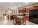 Eat-in kitchen with dark wood cabinets and black appliances, seamlessly connected to the living area at 20555 N 261St Ave, Buckeye, AZ 85396
