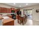 Eat-in kitchen featuring wood cabinets, black appliances, and an inviting patio view through sliding glass doors at 20555 N 261St Ave, Buckeye, AZ 85396