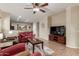 Comfortable living room with tile floors, a ceiling fan, and an open concept layout at 20555 N 261St Ave, Buckeye, AZ 85396