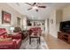 Spacious living room with wood-look floors, comfortable seating, and a ceiling fan at 20555 N 261St Ave, Buckeye, AZ 85396