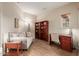Cozy home office space featuring built-in shelving, a comfortable sofa, and a dedicated work area at 20555 N 261St Ave, Buckeye, AZ 85396
