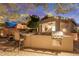 A charming outdoor kitchen and patio area, illuminated by string lights at dusk, ideal for entertaining guests at 20555 N 261St Ave, Buckeye, AZ 85396