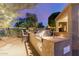 The outdoor kitchen area features a built-in grill and counter space, excellent for hosting summer barbecues at 20555 N 261St Ave, Buckeye, AZ 85396