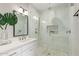Elegant bathroom with a single sink vanity and a glass-enclosed shower with pebble tile floor at 20801 N 90Th Pl # 169, Scottsdale, AZ 85255