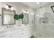 Elegant bathroom with a double sink vanity and a glass-enclosed shower with pebble tile floor at 20801 N 90Th Pl # 169, Scottsdale, AZ 85255