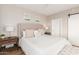 Bedroom with upholstered headboard, barn door, and matching lamps at 20801 N 90Th Pl # 169, Scottsdale, AZ 85255