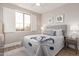 Bright bedroom with large window, upholstered bed, and decorative pillows at 20801 N 90Th Pl # 169, Scottsdale, AZ 85255