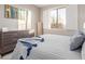 Bright bedroom featuring a large window, dresser, and cozy bedding at 20801 N 90Th Pl # 169, Scottsdale, AZ 85255