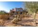 Desert-style home featuring stucco siding, a tile roof, and native landscaping at 20801 N 90Th Pl # 169, Scottsdale, AZ 85255