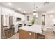 Modern kitchen boasts stainless appliances, white cabinets, and an island with barstool seating at 20801 N 90Th Pl # 169, Scottsdale, AZ 85255