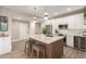 Modern kitchen with stainless appliances, white cabinets, large island, and wood-style flooring at 20801 N 90Th Pl # 169, Scottsdale, AZ 85255