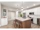 Modern kitchen with stainless appliances, white cabinets, large island, and wood-style flooring at 20801 N 90Th Pl # 169, Scottsdale, AZ 85255