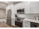 Modern kitchen with stainless steel appliances, white cabinets, and a cozy breakfast nook with window at 20801 N 90Th Pl # 169, Scottsdale, AZ 85255
