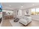 Bright living room features an open floor plan and flows seamlessly into the modern, all white kitchen at 20801 N 90Th Pl # 169, Scottsdale, AZ 85255