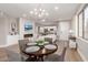 Bright open floor plan with fireplace, TV, and dining area adjacent to the modern, all white kitchen at 20801 N 90Th Pl # 169, Scottsdale, AZ 85255