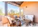 Relaxing covered patio featuring stylish wicker furniture, a glass table, and a peaceful desert landscape at 20801 N 90Th Pl # 169, Scottsdale, AZ 85255