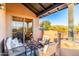 Cozy covered patio features comfortable wicker seating, a glass table, and scenic desert views at 20801 N 90Th Pl # 169, Scottsdale, AZ 85255