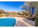 Relaxing poolside lounge area with comfortable chairs and umbrellas near the swimming pool at 20801 N 90Th Pl # 169, Scottsdale, AZ 85255