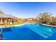 Community pool with blue water, spacious deck, and lounge chairs for relaxation at 20801 N 90Th Pl # 169, Scottsdale, AZ 85255
