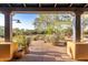 Covered porch featuring potted plants and a glimpse of the surrounding desert landscape at 20801 N 90Th Pl # 169, Scottsdale, AZ 85255