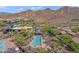 Aerial view of community pool with surrounding trees and mountain views at 2118 W Hunter Ct # 136, Phoenix, AZ 85085