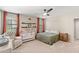 Bright bedroom featuring a crib, queen bed, ceiling fan, and natural lighting at 2118 W Hunter Ct # 136, Phoenix, AZ 85085